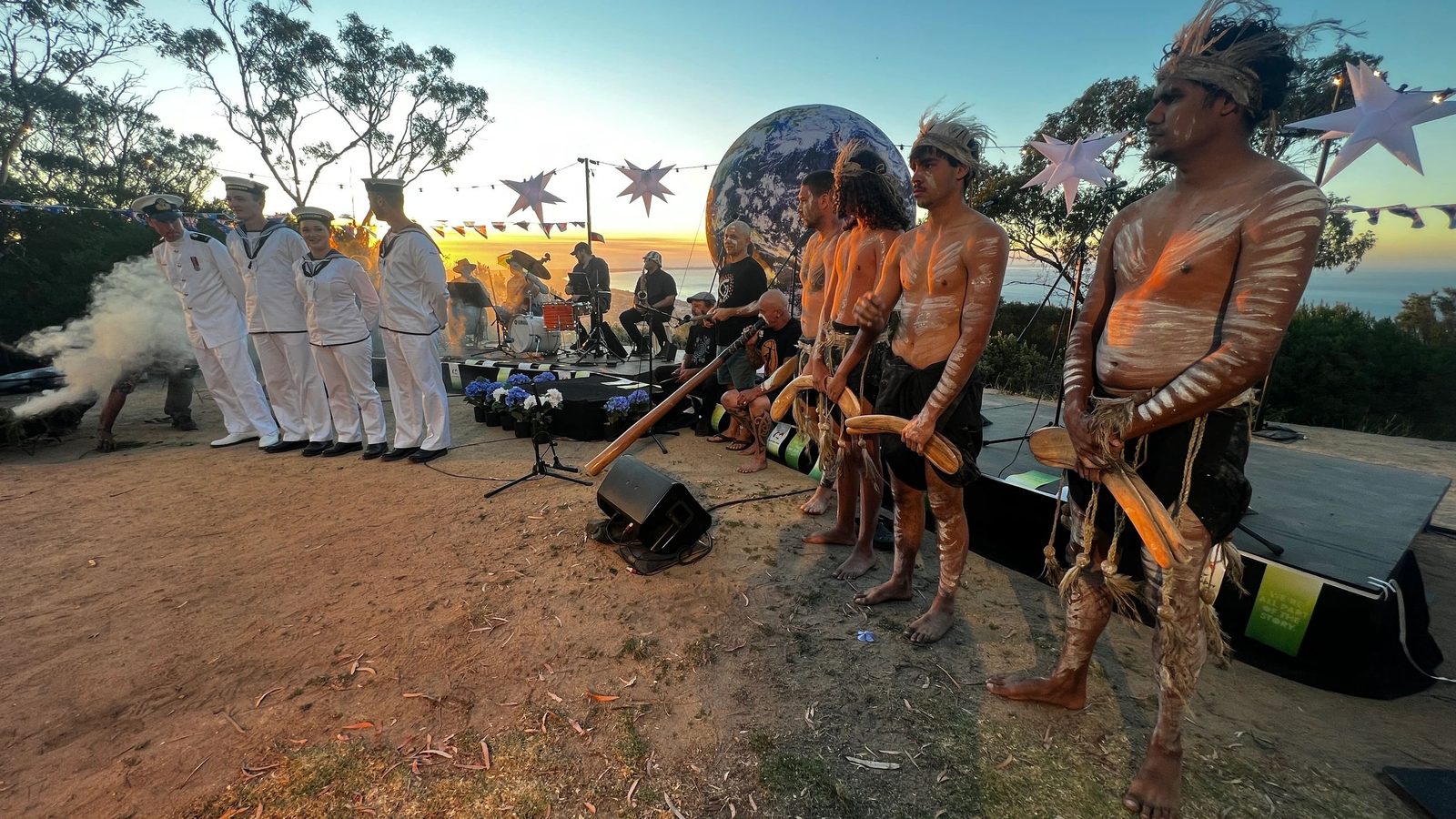 Community gathering at dusk during an outdoor ceremony on the Mornington Peninsula