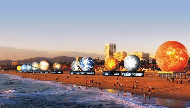 Planetary sphere installation on a beach at dusk
