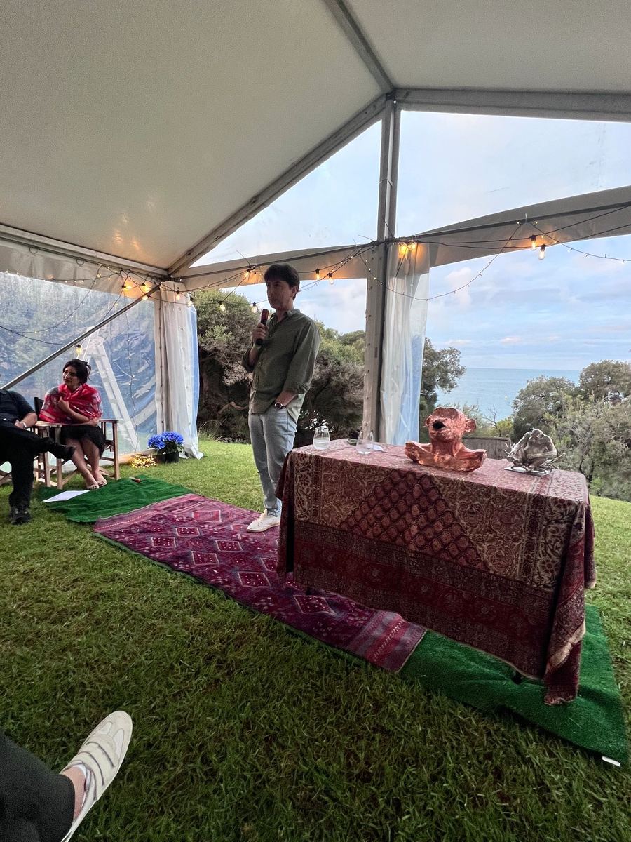 Sunset Garden Talk under a marquee with coastal views and festoon lighting